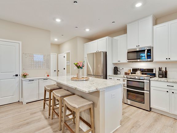 Beautiful, light, bright kitchen with tons of cabinets and countertop space. Kitchen includes a pantry cabinet and pantry with shelving.