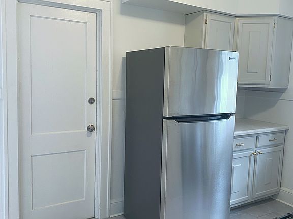 Kitchen with brand-new stainless steel 5-burner range, dishwasher. and refrigerator