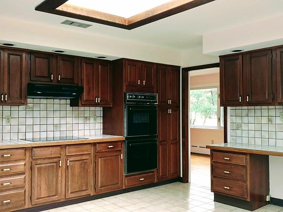 Large Kitchen features sky-light, flat top cooking surface and wall ovens.