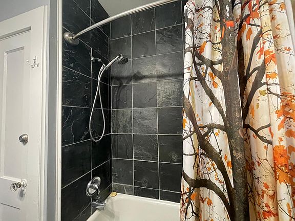 Bathroom includes a full tub and shower.