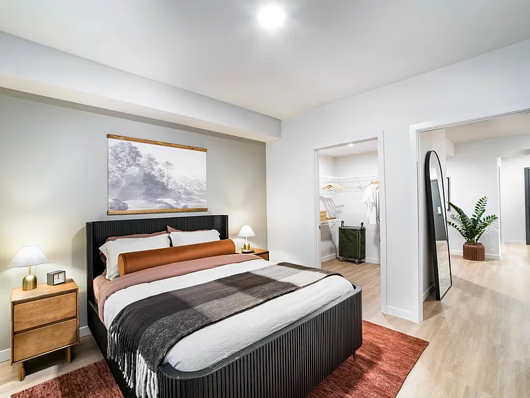 Retreat to your primary bedroom at Modera Shoreline, where warm tones and sleek finishes create a calm, inviting space to recharge.
