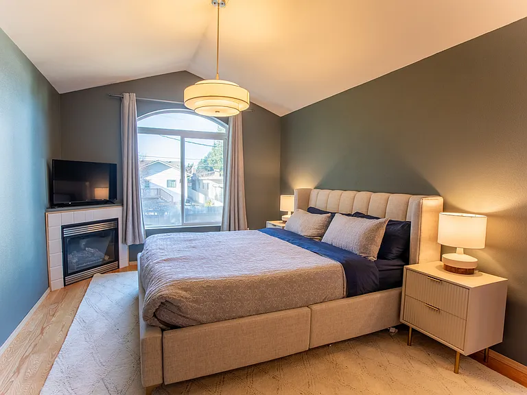 Primary suite includes vaulted ceilings, plenty of floor-space, and an attached private bathroom, double vanity and walk-in closet