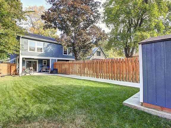 Backyard view with storage shed to the right (2 space parking behind fenced yard).