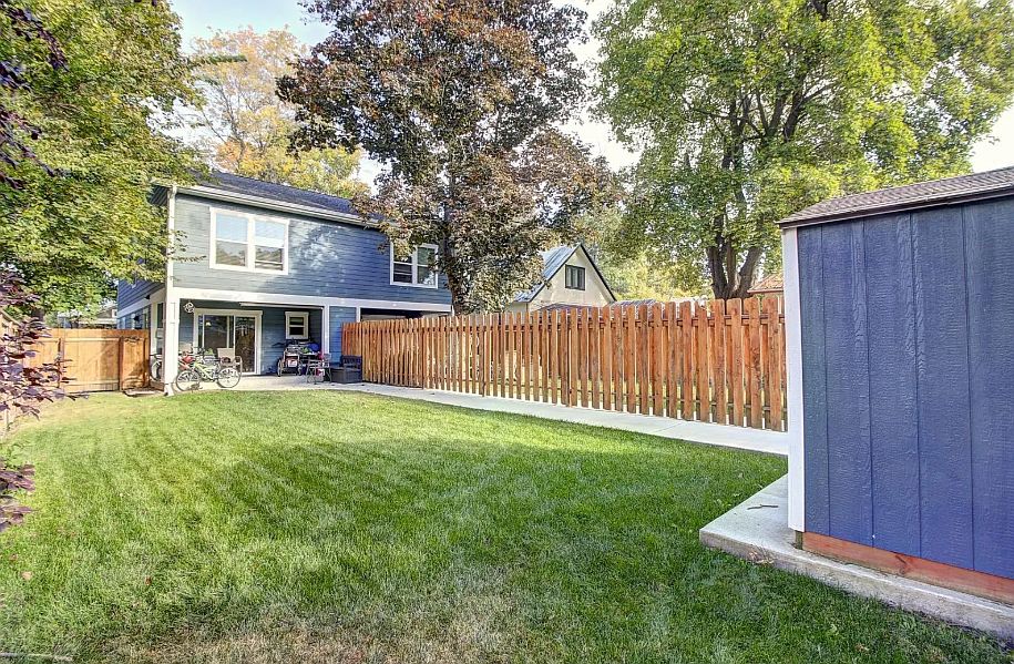 Backyard view with storage shed to the right (2 space parking behind fenced yard).