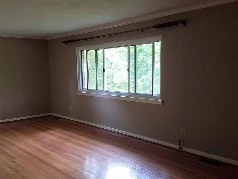 Large living room w entry closet, and wood floors throughout.