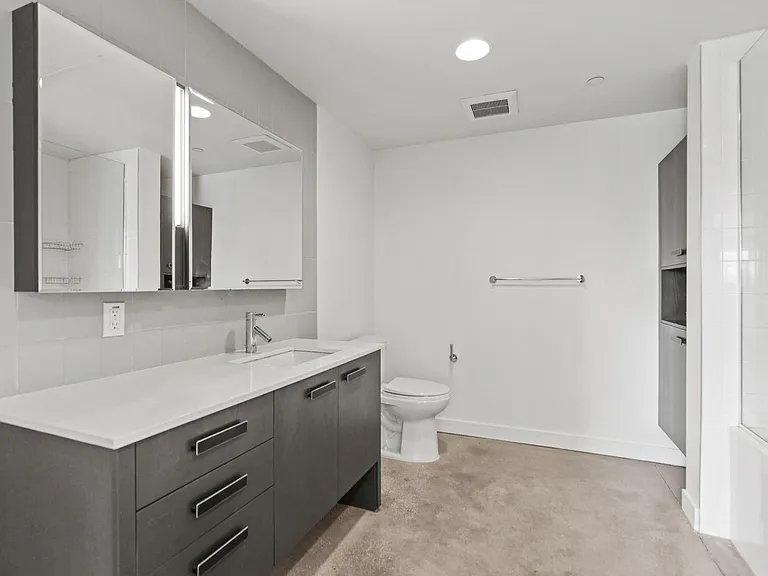 Bathroom with Full-Size Shower Bath with Glass Door and Built-In Cabinet Storage