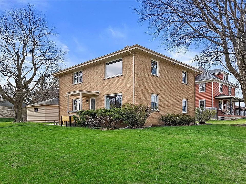 Street corner view of this lovely mid-century brick duplex near Lake Michigan and Downtown Port Washington.