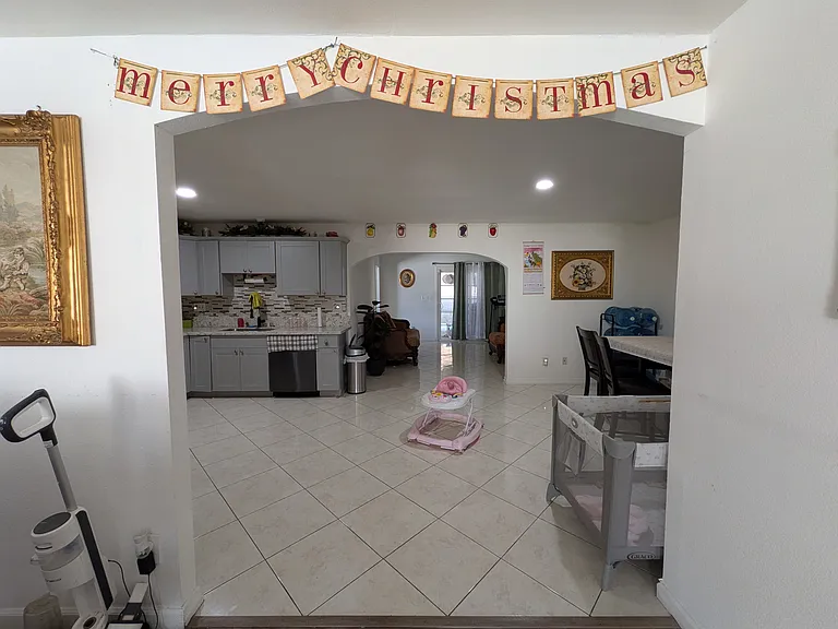 Shot of the indoor kitchen walkway connecting the areas between the backyard entrance and living/ dining area.