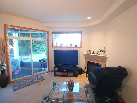 Living room opens out to deck with natural shade