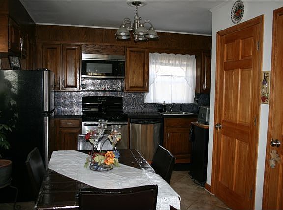 NEW KITCHEN W/ GRANITE, CERAMIC TILE, AND S.S APPLIANCES