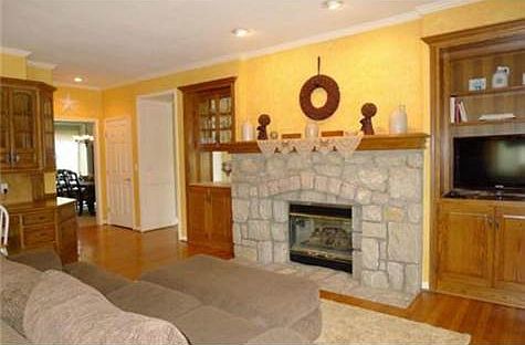 Built-ins flank the fireplace and offer entertainment center.