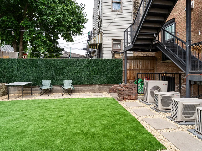 Community patio direct access from studio unit. With grilling, furniture, and dim lights for the evening. Beautiful gas fireplace will also be installed before move-in.