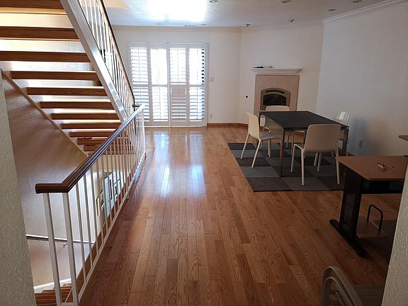 Living and dining room combined with gas fireplace and digital thermostat remote control. Furnishing pictured not included.