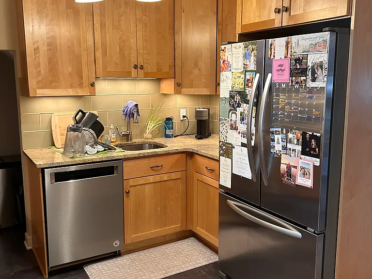 Kitchen with tile floor, KitchenAid dishwasher and fridge