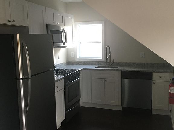 Kitchen with stainless steel appliances and white cabinets