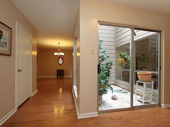 The atrium with natural light and gleaming hardwoods greet you as you walk in..