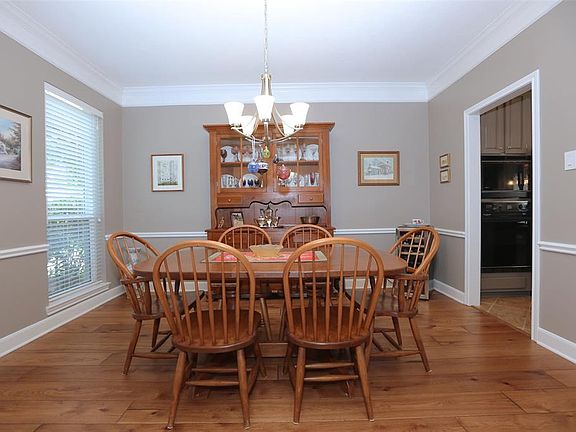 You'll enjoy holiday dinners in this formal dining room, with a graceful chair rail and warm wood floors.