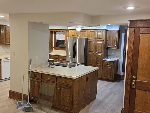 Large kitchen with nice wood cabinets, large island.