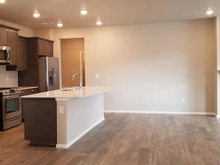 Open and inviting kitchen and living space. Modern hardwood floor.