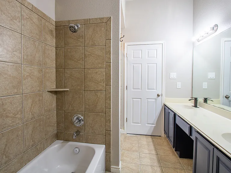 Master bathroom looking from the linin closet and toilet