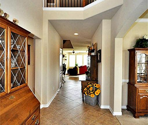  ALTERNATE VIEW OF ENTRY LOOKING OUT TO THE LIVING ROOM, AND SECOND FLOOR BALCONY