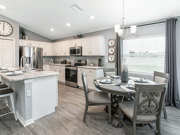 Your kitchen and dining cafe are fully open to the gathering room - Begonia home plan by Highland Ho