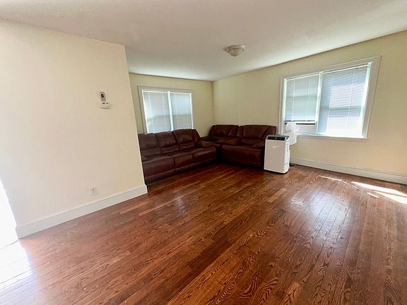 Living Room - 1st Floor - Unfurnished living room with dark hardwood / wood-style flooring