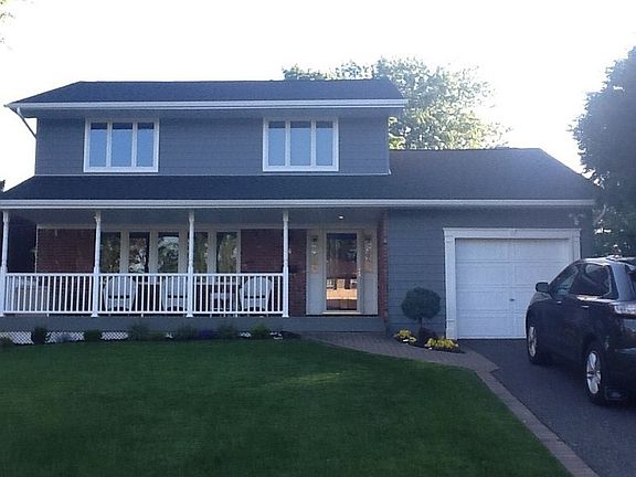 View From Street : One year old roof, siding and porch.