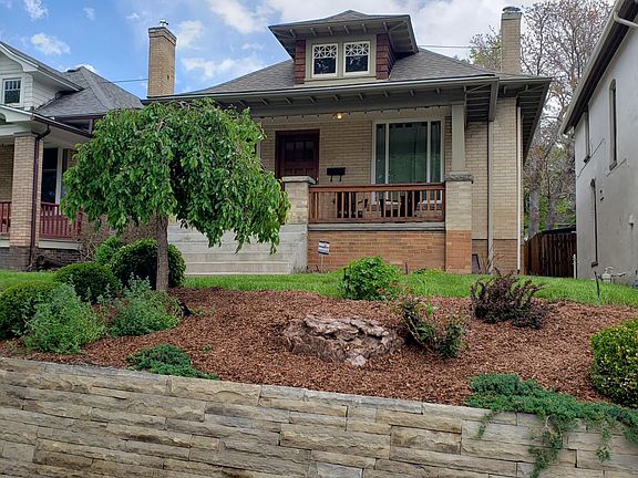 Professionally landscaped front yard with charming front porch.