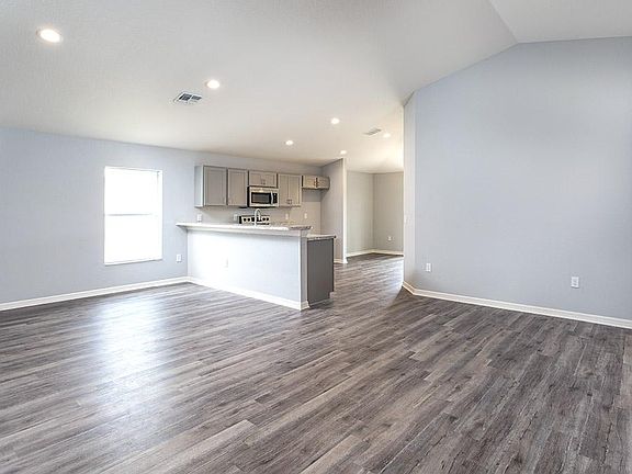 A spacious, open living area welcomes you home - Hibiscus home plan by Highland Homes
