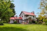 Main house east side, within fenced yard with vegetable and flower garden