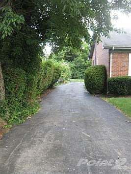 Long, fully paved driveway leading to a ramp for easy accessibility, Unit A.