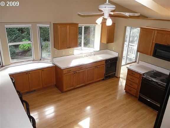 Kitchen with bar that looks into home theatre-family room