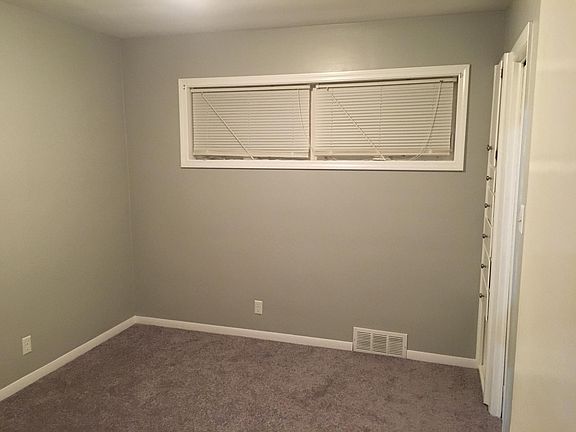 Rear Bedroom - updated with fresh paint/new carpet, features built-in drawers and cabinets. Smart closet design increases storage ability