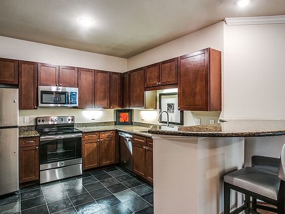 Gourmet kitchens featuring granite countertops and slate flooring