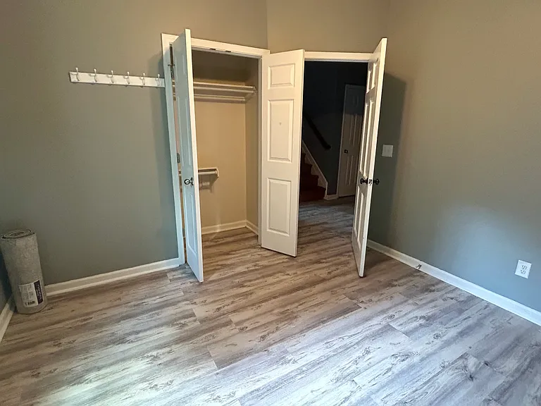 Another view of bedroom 4. Again, all downstairs bedrooms feature a coat rack, built-in shelf, and closet, perfect for organization.