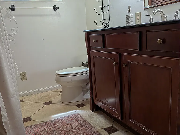 Garden level bathroom in the Suite with shower, heated tiles, closets and its own washer/dryer