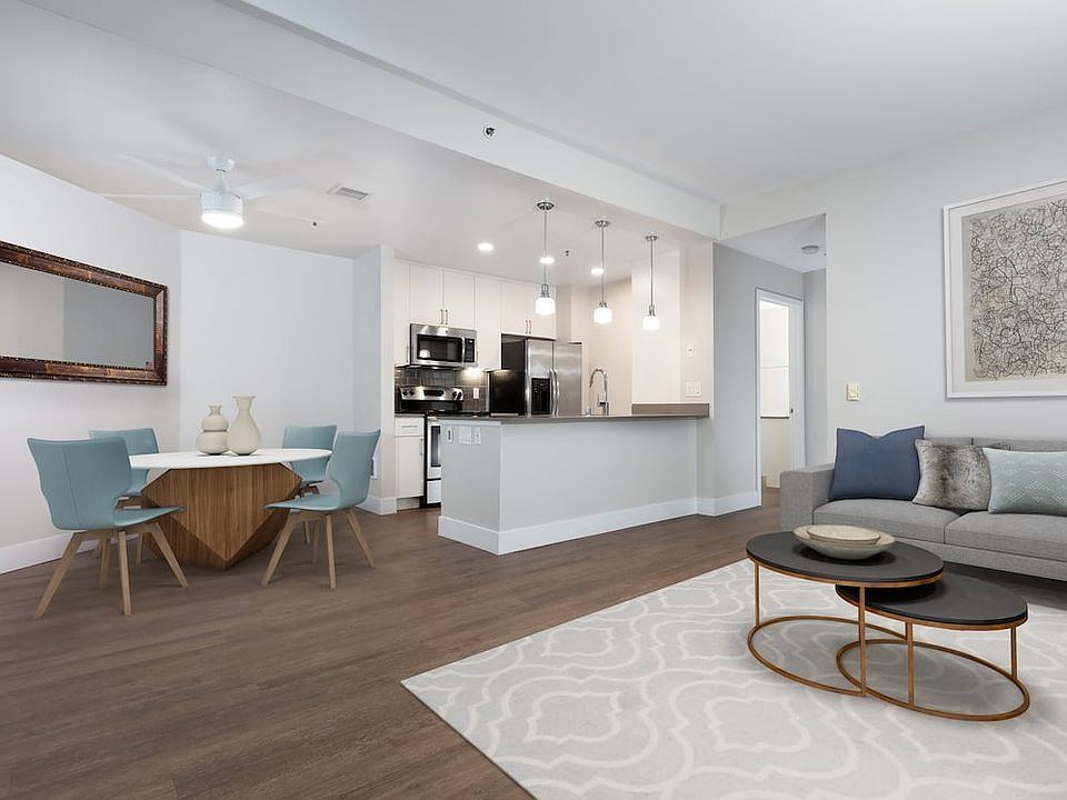 Renovated Phase I kitchen with quartz countertops, tile backsplash, and stainless steel appliances