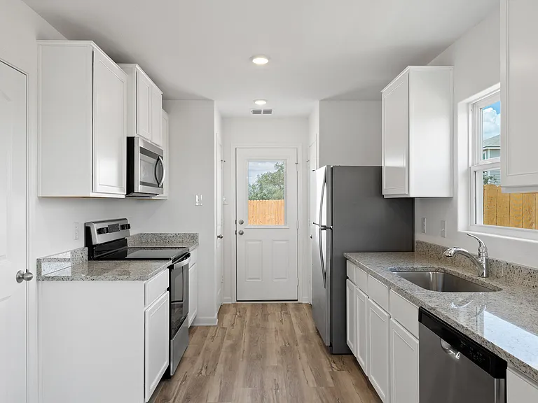 The door in the kitchen leads to the back yard.