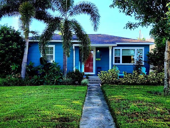 Spacious front yard in a quiet neighborhood with peacocks strolling throughout the area.