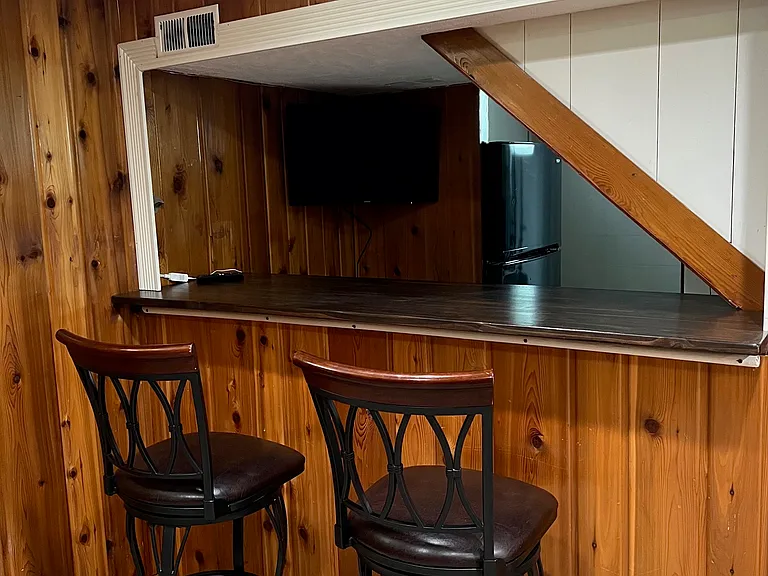 Bar area in the basement - Stools, tv and fridge in basement stay for thenant's use