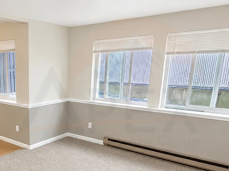 Large windows bring in natural light, creating an open and inviting feel throughout the living space.