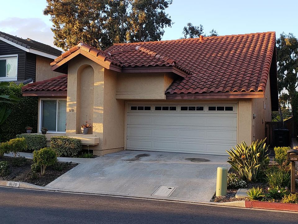 Front of house, note that there is a sloped driveway