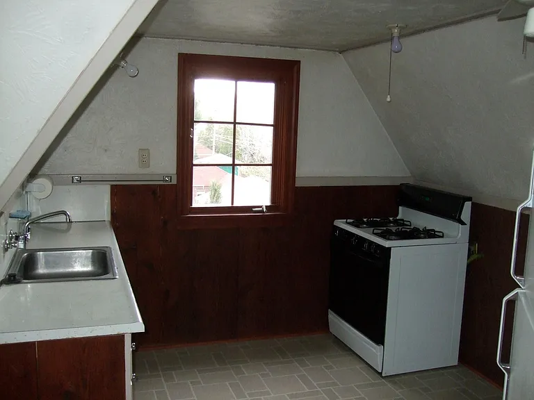 Nice kitchen with refrigerator and gas stove.