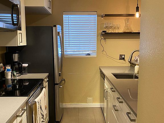 Remodeled kitchen fully stocked for cooking, featuring heated floors.