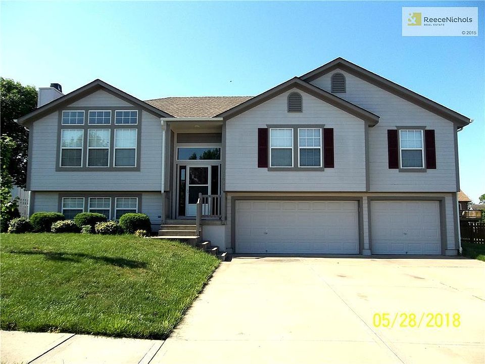 A Split-Entry style home with 3 Car Garage at 1503 Birch Drive, Greenwood, MO 64034.