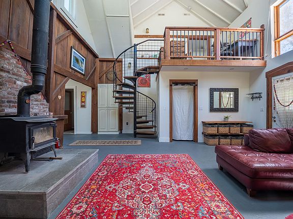 living room spiral staircase to loft