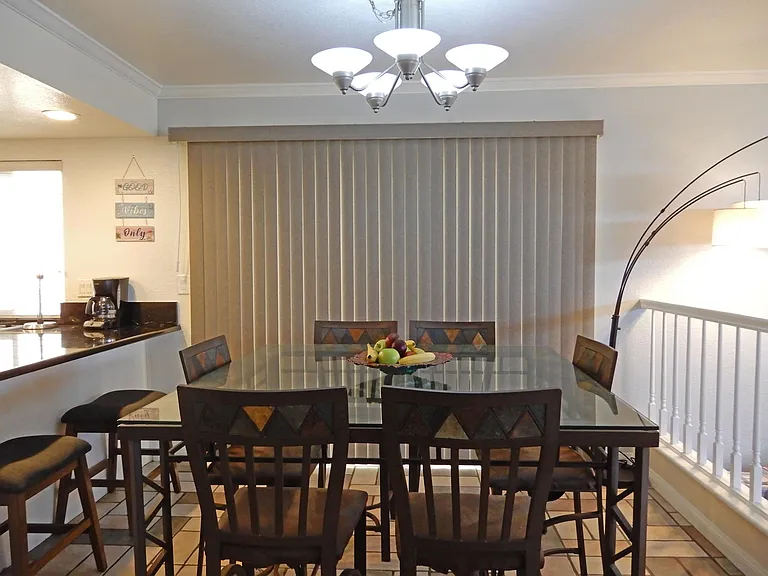 Dining room. Bar Height Table for 8. Patio Door to side yard with Gas Grill.
