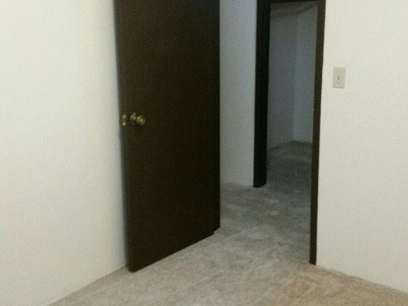 Bedroom and extra storage closet across the hall