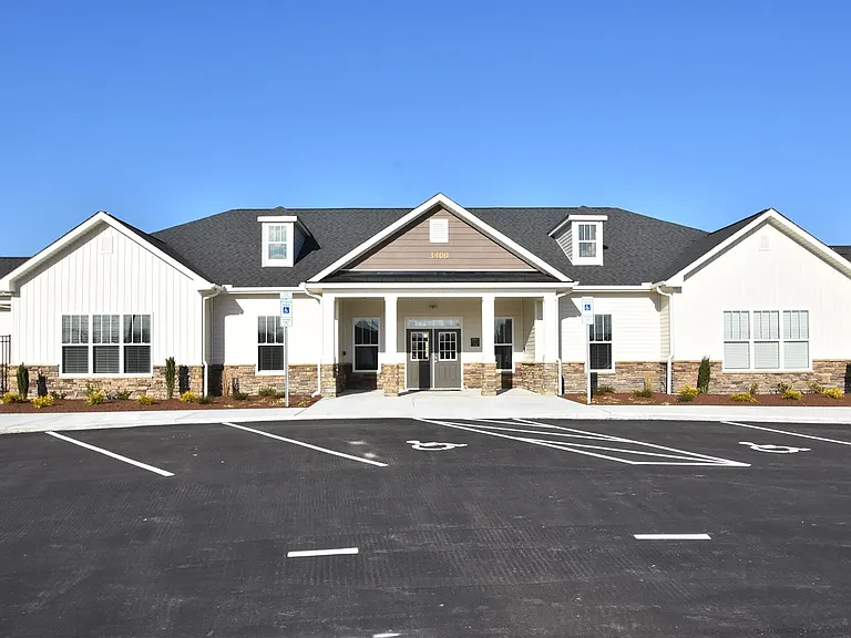 Shown here, is The Clubhouse which houses The Berkeley's leasing office, indoor lounge area, communal kitchen and dining space, 24-hour fitness center, Amazon Package Hub, and pool bathrooms.
